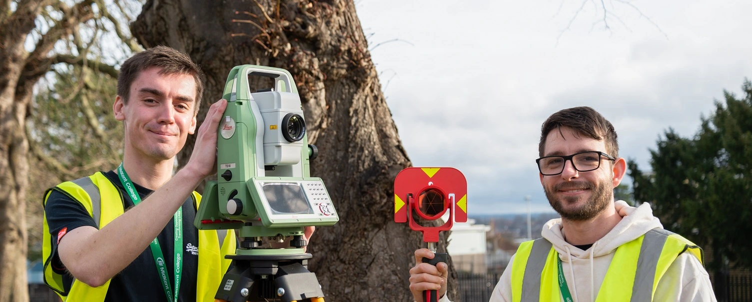 Students using surveying equipment